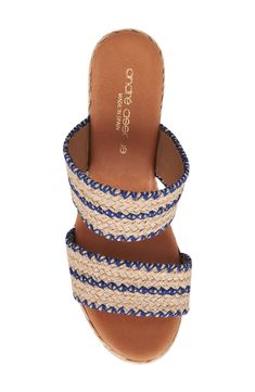 Woven raffia creates a boho aesthetic on an espadrille-inspired slide sandal lofted by a subtle platform and wedge heel. 3" heel; 1/2" platform Cushioned footbed Textile upper/leather lining and sole Made in Spain Beach Mules With Stacked Wedge Heel, Beach Wedge Heel Mules With Stacked Heel, Casual Wedge Sandals With Stacked Heel For Vacation, Blue Espadrilles With Woven Sole For Beach, Cushioned Wedge Heel Mules For Vacation, Vacation Mules With Cushioned Footbed And Wedge Heel, Casual Straw Sandals With Stacked Heel, Blue Cushioned Espadrilles For Beach, Blue Wedge Sandals With Woven Sole For Vacation