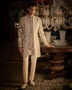 This set features white dori embroidery in an abstract pattern. The ensemble is paired with a fully embroidered kurta and white straight pants. Complimenting footwear is also available. DELIVERY TIMEPlease allow 8-12 weeks for your outfit to arrive. FABRIC DETAILSSherwani- Silk, Kurta - Cotton Silk, Trouser - Stretchable TR Professional cleaning only. Indowestern Outfits For Men, Western Outfits For Men, White Straight Pants, Indo Western Outfits For Men, Indo Western Dress For Men, Indian Wedding Suits Men, Indian Wedding Clothes For Men, Dori Embroidery, Seema Gujral