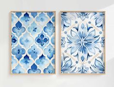 two blue and white tiles hanging on the wall