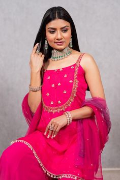 Hot pink embroidered strappy kurta with mirror and gota detail. Paired with solid sharara and dupatta.
Component: 3
Pattern: Hand embroidered
Type Of Work: Sequin work, Nalki work, Mirror work, Mukaish work
Neckline: Square
Sleeve Type: Sleeveless
Fabric: Organza, Georgette, Net
Color: Pink
Other Details: 
Ombre dupatta
Occasion: Reception,Wedding - Aza Fashions Pink Chanderi Sharara With Dabka Work, Pink Chinon Sharara With Dabka Work, Festive Pink Sharara With Dabka Work, Pink Chinon Sharara For Eid, Designer Pink Sharara With Dabka Work, Designer Pink Sharara With Dori Work, Pink Chinon Sets With Zari Work, Festive Pink Sharara With Gota Work, Pink Dori Work Kurta For Party