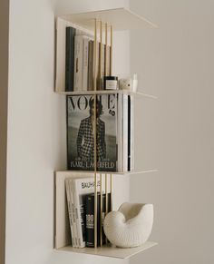 two shelves with books and magazines on them