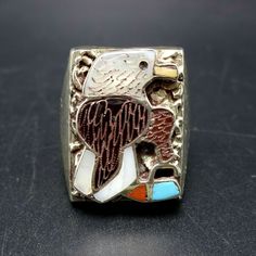 "ZUNI EAGLE INLAY RING DESCRIPTION: This handsome ring features perfect inlay of blue turquoise, mother of pearl, red coral, black jet, and brown shell set in heavy gauge vintage sterling silver. This ring will be a treasured addition to your collection of fine Native American jewelry. MEASUREMENTS: Ring face measures 7/8\" x 5/8\" RING SIZE: 11 WEIGHT: 19.6 grams SIGNED: yes (Zuni) STERLING: unmarked, verified STERLING" Collectible Vintage Turquoise Ring With Polished Finish, Collectible Silver Rings With Inlay, Vintage Turquoise Ring With Polished Finish, Southwestern Inlay Jewelry For Anniversary, Southwestern Style Inlay Jewelry For Anniversary, Silver Rings With Inlay For Collectors, Vintage Sterling Silver Turquoise Ring With Inlay, Vintage Multicolor Inlay Jewelry, Vintage Multicolor Inlaid Jewelry