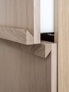 a close up of a wooden door with a white light in the center and wood grain on the bottom