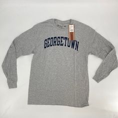 Condition: New With Tags Size: Multiple Sizes Color: Grey T-Shirt With A Navy Blue Graphic Retail: $39.98 45 Available Super Soft 90% Cotton / 10% Poly Long Sleeve Tee Shirt From The Victory. 100% Authentic Ncaa Apparel With Classic Georgetown Lettering On Chest. Perfect Basketball, Hoyas, Ncaa Basketball, Around Campus Long Sleeve T-Shirt. Sporty Gray T-shirt For Fall, Athletic Heather Long Sleeve T-shirt With Letter Print, Heather Grey Long Sleeve T-shirt For Streetwear, Gray Long Sleeve Casual T-shirt, Gray Crew Neck T-shirt For College, Pre-shrunk Long Sleeve College T-shirt, Casual Athletic Heather T-shirt With Letter Print, Gray Graphic Tee For Fall, Casual Gray T-shirt For College