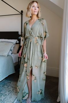 Our Kia Kimono Maxi Dress is perfect for any occasion! It features an olive and marigold floral print. This dress is great for maternity! Elegant Green V-neck Floral Dress, Flowy Dress With Kimono Sleeves For Brunch, Green Flowy Dress With Surplice Neckline, Green Surplice Neckline Dress For Garden Party, Bohemian Dresses With Floral Print And Surplice Neckline, Feminine Floral Print Maxi Dress With Surplice Neckline, Green Floral Print V-neck Dress, Green V-neck Wrap Dress For Brunch, Green V-neck Dress With Floral Print