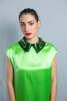 "A classy, stylish and elegant, green silk shirt, with a unique, detachable green, butterfly wings collar. The collar print is inspired from the wings of the Cairns Birdwing butterfly of Australia and attaches to the shirt by a zipper. This smart design allows you to add different collars to your silk shirt from our amazing collection of butterfly wing collars. The shirt is cut in a flattering, loose fitting style in a single color to complement the show-stopping vibrant print of the collar. Tog Silk Collar Blouse For Party, Green Collared Summer Blouse, Silk Party Top With Collar, Silk Evening Blouse With Collar, Elegant Summer Tops With Detachable Collar, Green Summer Evening Tops, Elegant Green Formal Tops, Summer Evening Green Tops, Summer Formal Blouse With Fold Down Collar