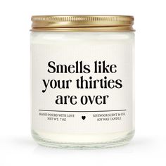 a candle with the words smells like your thries are over on it's lid