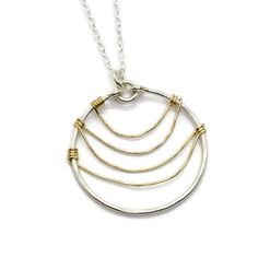 Ripple Silver and Gold Necklace $45.00 https://cloverleafjewelry.com Sterling Silver Circular Necklace With Large Pendant, Sterling Silver Necklace With Large Round Disc Pendant, Sterling Silver Necklace With Large Circular Pendant, Sterling Silver Circle Necklace With Large Pendant, Sterling Silver Coin Pendant Jewelry, Modern Round Wire Wrapped Jewelry, Modern Wire Wrapped Round Jewelry, Hammered Sterling Silver Round Pendant Jewelry, Hammered Sterling Silver Round Pendant