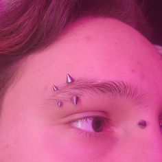 a woman with some piercings on her forehead