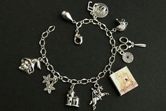 "A collection of silver plated charms, themed after the German fairy tale \"Rapunzel\" included in the Brothers Grimm's 1812 edition of \"Children's and Household Tales\", have been dispersed around a shimmering silver plated bracelet chain in this handmade charm bracelet. This Rapunzel charm bracelet is then completed with a lobster clasp and a 1/2 inch of chain at the end for adjustable sizing. Charms in this bracelet include a handmade \"Rapunzel\" book charm, a knight charm, castle tower cha Whimsical Silver Charms For Gifts, Whimsical Nickel-free Silver Charm Bracelet, Whimsical Silver Charm Bracelet, Themed Silver Charm Bracelet, Handmade Themed Silver Charm Bracelet, Themed Charm Bracelet For Jewelry Making, Rapunzel Bracelet, Rapunzel Book, German Fairy Tales