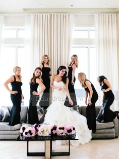 a group of women standing next to each other in front of a couch