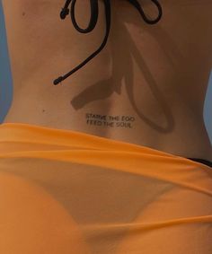 the back of a woman's stomach with writing on it