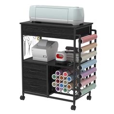 a printer and some craft supplies on a cart