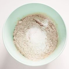 a bowl filled with dry ingredients on top of a table