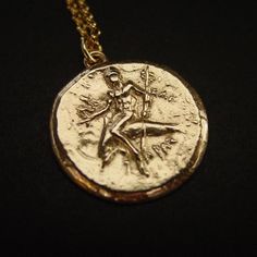 Taras Boy on Dolphin Coin Reproduction Necklace | Ancient Greek Coin Jewelry Symbolic Brass Coin Necklace, Mythological Medallion Jewelry Gift, Ancient Style Coin Necklace With Round Pendant, Ancient Style Round Pendant Coin Necklace, Mythological Medallion Jewelry In Gold, Mythological Style Gold Coin Pendant Jewelry, Gold Mythological Coin Pendant Jewelry, Gold Mythological Jewelry With Coin Pendant, Mythological Round Pendant Jewelry As Gift