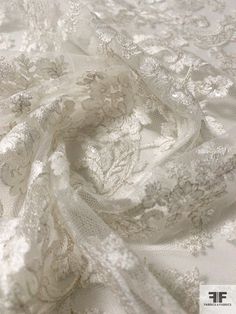 an image of white fabric with lace on it