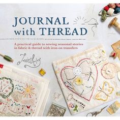 the cover of a book with embroidered items on it and sewing supplies in front of it