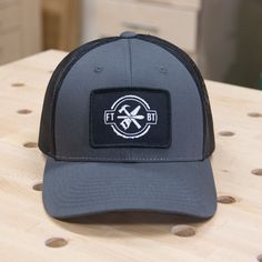 The second edition FTBT Trucker Hat. This hat is from Beach & Barn and replicates a Richardson 115 Low Profile Trucker hat with a 3" x 2" embroidered patch with a raised merrowed edge. Hat has a mesh back with plastic snapback fitting. I'm not gonna lie, these hats are amazing. Shipping in the U.S. only. Hats are shipped from a different location than shirts, so shipping will be separate for each. Gray Trucker Hat With Logo Patch, Functional Moisture-wicking Trucker Baseball Cap, Adjustable Six-panel Trucker Hat With Logo Patch, Adjustable Western 5-panel Trucker Hat, 5-panel Mesh Trucker Hat With Logo Patch, Embroidered Patch, Embroidered Patches, Low Profile, Trucker Hat