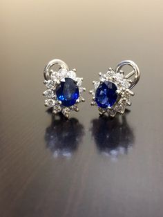 DeKara Designs Collection Metal- 90% Platinum, 10% Iridium. Stones- 2 Oval Shaped Ceylon Blue Sapphires 1.20 Carat each, 24 Round Diamonds G Color VS2 Clarity, 1.05 Carats. Beautiful Art Deco Inspired Handmade Platinum Ceylon Blue Sapphire Diamond Halo Earrings. The entire earrings are hand assembled, the back of the earrings are made in 90% platinum. The sapphires are sitting in between 4 prongs, and the diamonds are surrounding them and prong set as well. The sapphires are perfectly matching i Gia Certified Cluster Earrings For Formal Occasions, Gia Certified Sapphire Diamond Earrings For Formal Occasions, Luxury Oval Sapphire Earrings, Formal Gia Certified Sapphire Diamond Earrings, Luxury Oval Cluster Earrings For Formal Occasions, Classic Clip-on Cluster Earrings For Formal Occasions, Classic Clip-on Cluster Earrings For Formal Events, Formal White Gold Cluster Earrings Hallmarked, Formal Cluster Earrings With Brilliant Cut