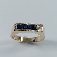 This Handmade Sapphire and Diamond Ring has been carefully crafted in 10k Yellow Gold, Authentic White Diamonds  and Authentic Sapphire. This delicate ring would make an amazing birthday/any occasion gift. Ring will be shipped to you in an elegant gift box and it can resized at no extra cost. Once the ring has been mailed a tracking shipping number will be provided to you. Sapphire Measurements: 4 Sapphire: 2.5 mm x 2.5 mm Diamond Measurements: 2 Diamonds, each stone is 1.5 mm, 0.015 cts, total 14k Gold Blue Diamond Ring, 14k Gold Blue Ring With Prong Setting, Blue 14k Gold Ring With Prong Setting, Blue 14k Gold Ring Stamped 14k, Blue 14k Gold Rings For Anniversary, Blue 14k Stamped Promise Ring, Formal Three Stone Sapphire Ring In 14k Gold, Formal Three-stone Sapphire Ring In 14k Gold, Sapphire Ring Stamped 14k Round Cut