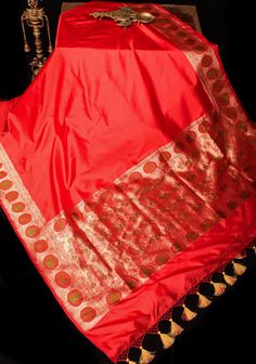 The charming-hued Red Banarasi Katan Silk Saree with a fancy Meenakari Border and Pallu looks just as delightful as it is in the pictures. It's a perfect blend of sophistication and heritage.  The smooth Katan silk material ensures both comfort and luxuriousness. The detailed color blocking adds a touch of royalty to this saree, while the enchanting Meenakari Zari Border brings out its feminine and graceful side.  SILK MARK CERTIFIED This saree is ready to wear with fall and pico done. Handmade silk tassels adorn the pallu and add more grace to it. An unstitched blouse fabric is included. *Note: There may be minor variations in the shade, the texture of the product. Hues/textures show differently due to variations in screen settings and other factors, *Note: This is a handwoven saree and t Luxury Red Katan Silk Blouse Piece, Luxury Katan Silk Blouse For Puja, Luxury Katan Silk Saree With Meenakari Detail, Luxury Katan Silk Unstitched Blouse, Luxury Katan Silk Sets With Pallu, Luxury Unstitched Silk Mark Certified Traditional Wear, Luxury Unstitched Katan Silk Blouse, Luxury Unstitched Silk Mark Certified Saree, Banarasi Katan Silk Saree