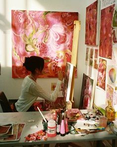 a woman is painting in an art studio