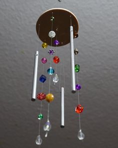 a wind chime with multicolored beads hanging from it