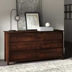 a wooden dresser sitting next to a white rug