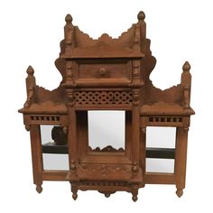 an old wooden cabinet with mirrors on it