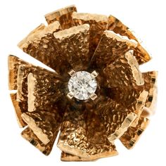 Gold Ring centered by a round cut diamond. Dimensions: Stylized Flower design: 2.20 x 2.20 centimeters. Total weight: 14.49 grams. Aesthetic Movement, Gold Diamond Rings, Round Cut Diamond, Flower Design, Flower Designs, Gold Ring, Fashion Rings, Round Cut, Gold Rings