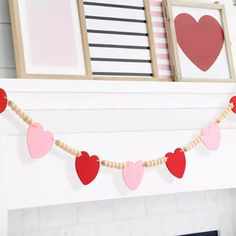 valentine's day garland with hearts hanging from the mantle