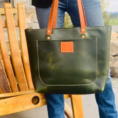 Luxury Green Leather Tote Bag. Panhandle Red's Original Design and Craftsmanship. Panhandle Red Leather Company. 100% Handcrafted Products, Made in Idaho, USA. NAME: THE WESTWOOD GREEN TOTE High Quality Material: Panhandle Red Company is in Post Falls, Idaho. We are a custom leather shop, we build all our leather products by hand. We only use American Full Grain Leathers, they are the best. Designed and Handcrafted by Panhandle Red Full Grain Green Leather Copper Rivets Inside and Outside Pockets Zipper Closure Perfect for Laptop or Professional Needs Approximate Measurements: 14 High x 18 Wide x 3 Inch Bottom Made in Idaho, USA Post Falls Idaho, Luxury Green, Brown Leather Tote Bag, Green Tote, Leather Company, Brown Leather Totes, Leather Products, Tote Bag Purse, Hand Crafted Gifts