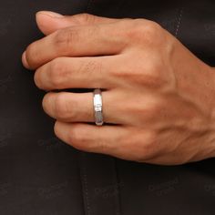 a man's hand with a ring on his finger