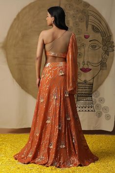 Rust orange textured lehenga with placement embroidery. Paired with a gathered blouse with matching texture and embroidery on neckline and a ruffled net dupatta. - Aza Fashions Orange Sets For Reception And Festivals, Orange Choli With Dupatta For Reception, Orange Lehenga For Festivals And Reception, Orange Lehenga For Reception And Festivals, Orange Pre-draped Saree With Unstitched Blouse For Party, Orange Traditional Wear For Diwali Reception, Orange Traditional Wear For Reception And Diwali, Festive Orange Lehenga With Sheer Dupatta, Orange Choli With Traditional Drape For Reception