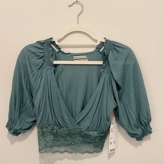 Urban Outfitters Samara Plunging Surplice Crop Top Nwt Size: Small Color: Teal Plunging V-Neck With Elastic Lace Waistband Ruffle Trim At Shoulders, Elastic Sleeve Cuffs V-neck Crop Top With Lace Trim For Spring, Urban Outfitters Tops With Lace Trim For Spring, Low-cut Blue Summer Tops, Chic V-neck Lace Crop Top, Elegant Low-cut Top For Spring, Urban Outfitters V-neck Crop Top, Open Neckline Tops For Night Out In Spring, Spring V-neck Blouse By Urban Outfitters, Urban Outfitters V-neck Spring Blouse