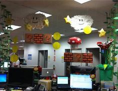 an office cubicle decorated with paper decorations and laptops