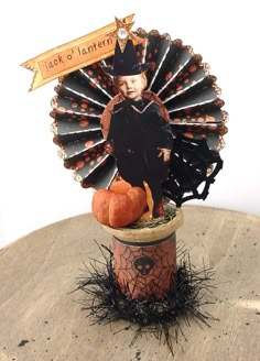 a scarecrow is sitting on top of a pumpkin