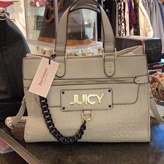 Bag Is Light Gray With Gold Tone Hardware. Inside Is The Black & White Juicy Lining. Has Open Pockets & A Zipper Pocket. Bag Is 9x12x6. Has Detachable & Adjustable Strap. The Juicy Name Is On The Front Zipper Pocket. Trendy Gray Satchel For Shopping, Trendy Beige Bag With Branded Hardware, Chic Gray Bag With Top Carry Handle, Gray Bag With Branded Hardware For Daily Use, Gray Rectangular Shoulder Bag With Branded Hardware, Gray Zipper Bag For Shopping, Luxury Gray Bag With Zipper Closure, Chic Gray Shoulder Bag With Branded Hardware, Hot Pink Bag