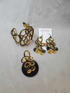 "Black and gold colored jewelry set, this beautiful cuff bracelet, ring, and matching earrings are a statement set that will get plenty of compliments. Made of non-tarnish, lightweight aluminum wire. The cuff is adjustable and the earrings are 3\" long with surgical steel ear wires. Be sure to choose your ring size. I want my customers to be happy, so please look carefully at the photos, and feel free to ask any questions. I post new items as soon as they are created so please come back and visi Adjustable Bangle Jewelry For Evening, Adjustable Bangle For Evening Wear, Adjustable Bangle For Evening, Unique Evening Bracelet Jewelry, Handmade Adjustable Gold Jewelry Sets, Adjustable Gold Jewelry Sets With Matching Earrings, Handmade Adjustable Jewelry For Evening, Unique Black Bangle Jewelry, Handmade Evening Bracelet Jewelry