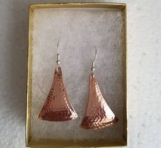 Hammered copper earrings with a sterling silver ear wire. The hammering technique I do domes them slightly for a nice effect, and hardens the metal a little so they hold their shape well. They are available in size small, 7/8ths of an inch long, medium, 1&1/4 inch long, and large 1&5/8ths of an inch. That is the length of the hammered piece. The ear wire adds about a 1/2 inch. They are not heavy. Shipped in a gift box to protect during shipment. I also have this style listed in sterling Rose Gold Hammered Metal Earrings, Hammered Rose Gold Copper Earrings, Hammered Copper Earrings For Gift, Hammered Silver Earrings Made Of Copper, Hammered Silver Copper Earrings, Silver Hammered Copper Earrings, Hammered Copper Drop Earrings, Hammered Copper Earrings Rustica Jewelry, Rustic Hammered Copper Earrings