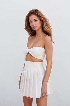 This two-piece set is a perfect choice for summer! The white top is strapless and has a bow detail in the front, adding a touch of femininity. The skirt is pleated and hits just above the knee, making it both stylish and comfortable. The set is made from a soft ribbed fabric, perfect for cold weather. The simple design of the set makes it easy to dress up or down, making it versatile for a variety of occasions. Composition: 100% microfiber polyamide, ribbed fabric Wash and care: wash at 30°c and White Skirt And Top, August Birthstone Jewelry, Top Skirt Set, Gifts For New Mums, Pearl Jewellery Earrings, August Birth Stone, Independent Designers Fashion, Bow Detail, Ribbed Fabric