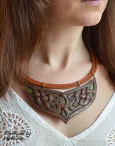 "Celtic elven bib necklace is the unique and unusual jewelry for women made of polymer clay in the technique of leather imitation. Its brown and green colors together with Celtic weavings lead us to the fantasy world. This statement autumn colors fall jewelry can be an inspirational gift for a fairytales lover. Necklace central element size: 7,5 X 12,5 cm (2,95 X 4,92\") Cord length is adjustable from 46 to 53 cm (18,11 - 20,87\") If you need a longer (shorter) cord please contact me and I will Green Leather Jewelry Gift, Green Leather Jewelry For Gifts, Green Leather Jewelry As A Gift, Handmade Leather Necklace In Brown, Elegant Handmade Polymer Clay Necklaces, Handmade Green Fantasy Necklaces, Handmade Fantasy Green Necklaces, Handmade Green Fantasy Necklace, Handmade Green Polymer Clay Necklace