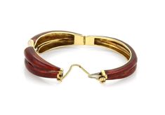 "This is an eye catching red enamel bracelet, it is crafted from solid 18k yellow gold with a double band style adorned with dark red guilloche enamel, the front center has a slanted cut out ends barely touching one end with diamond and the other with white enamel. This fine piece is hinged halfway across and the back is also in a double band style which is smaller then the stylish front, it fastens with a push in clasp and chain attached for added security. Material: 18k yellow gold. Measuremen Elegant Red Enamel Bracelets, Formal Enamel Bangle, Formal Round Enamel Bangle, Red Formal Bracelet Jewelry, Formal Yellow Gold Enamel Bracelets, Brown Bangle Jewelry For Formal Occasions, Brown Bangle For Formal Occasions, Guilloche Enamel, Enamel Bracelet