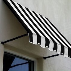 a black and white striped awning on the side of a building