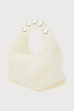 The luxe vibes will be off the charts when you pair your bougiest looks with the Lulus Upgraded Glam White Pearl Handbag! This iconic bag is composed of faux pearl beads that shape a bucket-like body with a flat bottom and a folding top. The interior pocket has plenty of space for all your chicest essentials, and oversized faux pearls form the handle that lends a stunning finish to this statement-making bag. Unlined. Bag Measures 9" Wide, 4" Tall, And 4. 5" Deep. Handles Have A 2" Drop. 100% Res Pearl Handbag, Novelty Handbags, Lulu Fashion, Pearl Bag, Iconic Bags, White Pearl, Handbag Accessories, Pearl Beads, Pearl White