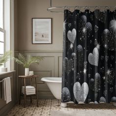 a black and white shower curtain with hearts on it