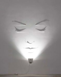 a light that is on in the middle of a room with eyes drawn on it