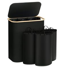 three black bags are sitting next to each other in front of a white background with the lid open