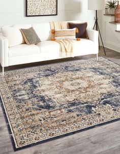 a living room with white couches and rugs