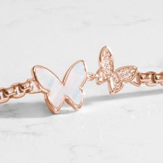 The Serenity medical ID bracelet features a beautiful, double butterfly centerpiece on a classic box chain, both plated in gorgeous 14k rose gold. Inlaid with iridescent mother of pearl and sparkling cubic zirconia crystals, these charming butterflies are the perfect representation of a special relationship - whether between mother and daughter, sisters, or best friends. This interchangeable bracelet pairs beautifully with your favorite custom-engravable gold tone medical alert tag from Lauren�s Adjustable Rose Gold Box Chain Jewelry, Adjustable Rose Gold Jewelry With Butterfly Charm, Rose Gold Adjustable Jewelry With Butterfly Charm, Rose Gold Butterfly Fine Jewelry, Rose Gold Butterfly Charm Jewelry As Gift, Fine Jewelry Rose Gold Butterfly Charm, Fine Jewelry Rose Gold Box Chain, Dainty Rose Gold Jewelry With Butterfly Charm, Rose Gold Jewelry With Butterfly Charm As Gift